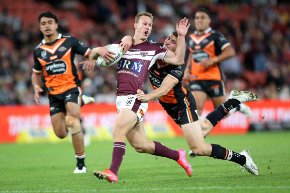 Daly Cherry-Evans is tackled at Suncorp.