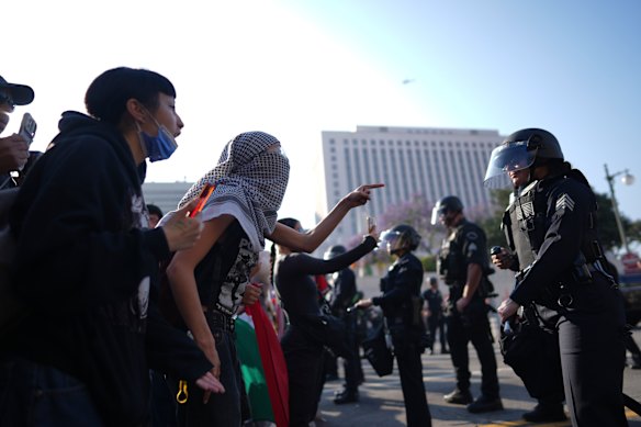 Protesters confront Los Angeles police department personnel in riot gear on Monday.