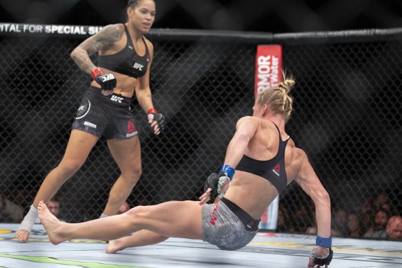 Down and out: Amanda Nunes, left, knocks out Holly Holm with a kick in the first round of their bantamweight contest.