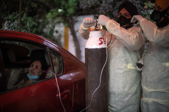 Volunteers treat patients suffering from Covid-19 with free oxygen at a makeshift clinic in a parking lot outside the Gurdwara Damdama Sahib on May 03, 2021 in New Delhi, India.