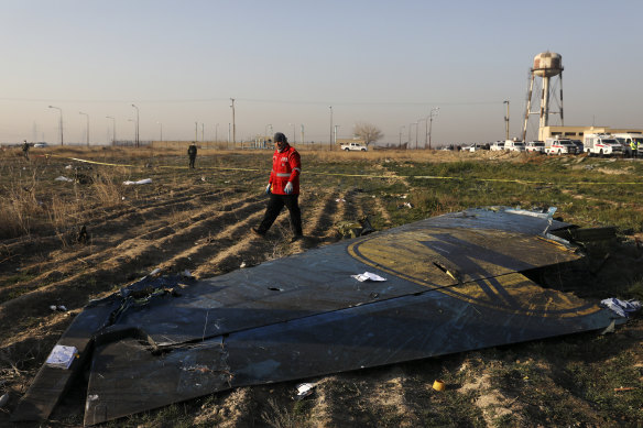 A rescue worker searches the scene where the Ukrainian plane crashed in Shahedshahr, south-west of the capital Tehran, Iran.