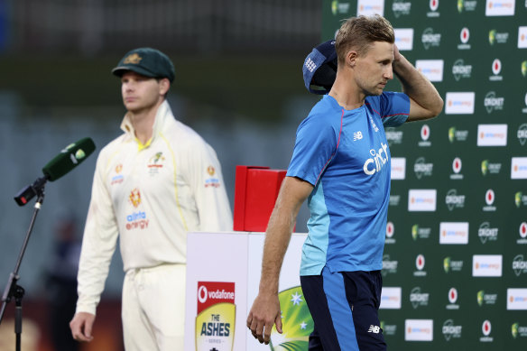 Joe Root, right, walks off the podium as his counterpart Steve Smith speaks.