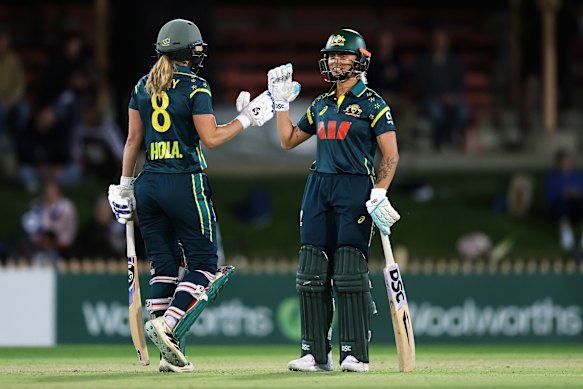 Ellyse Perry of Australia celebrates scoring a half century. 