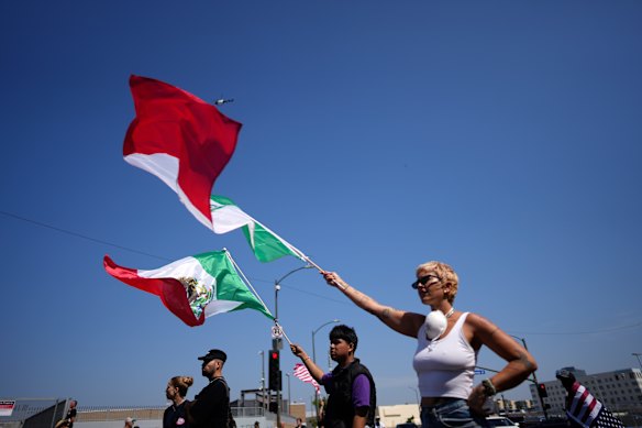 Protesters holding Mexican flags gather in downtown Los Angeles on Tuesday.
