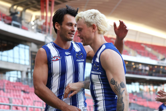 Robbie Tarrant and Jasper Pittard share a moment after winning their 150th games.