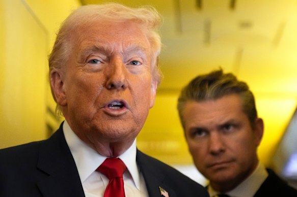 President Donald Trump speaking to reporters as War Secretary Pete Hegseth listened while travelling aboard Air Force One to Miami on the weekend.