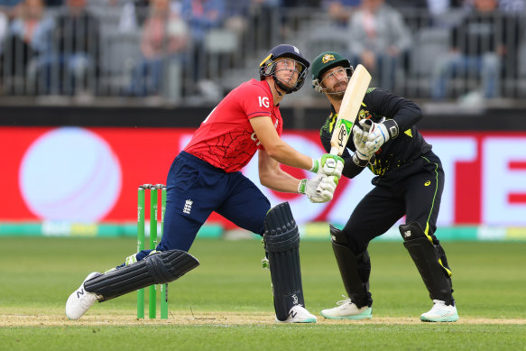 England’s Jos Buttler and Matthew Wade of Australia watch the ball go for six at Optus Stadium.