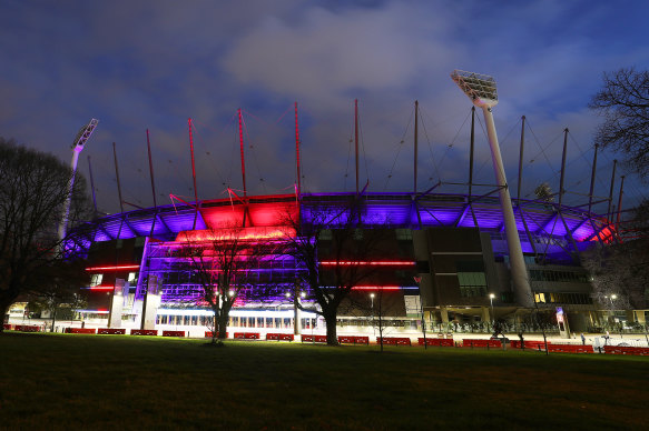 The MCG lit up in the Demons’ colours on grand final day 2021. There was no one inside.