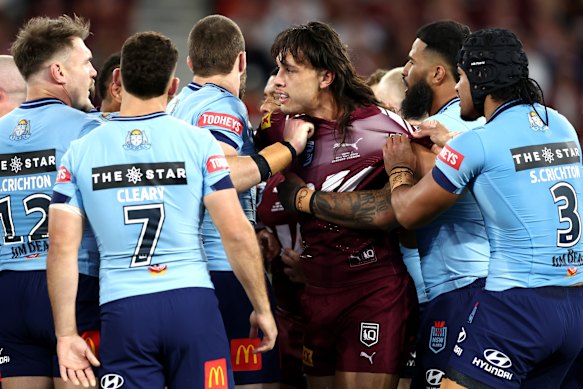 Outgunned: Tino Fa’asuamaleaui is surrounded by Blues players.