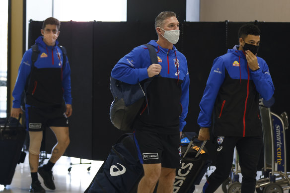 Tom Liberatore, Rohan Smith and Jason Johannisen at Melbourne Airport on Sunday.