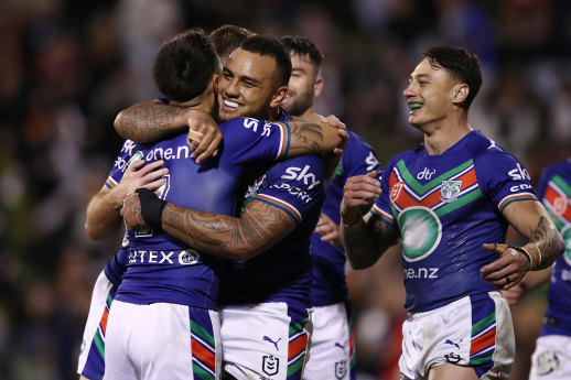 The Warriors celebrate a try during their 30-point thrashing of the Dragons.