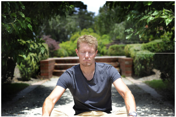 Matt Young, director of Melbourne Meditation Centre, meditating in St Kilda Botanic Gardens on Sunday.