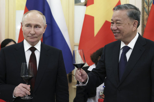 Old friends: Russian President Vladimir Putin and Vietnamese President To Lam toast during a gala reception after their talks in Hanoi on Thursday.