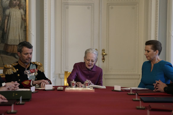 Denmark’s Queen Margrethe II signs a declaration of abdication in the Council of State at Christiansborg Palace in Copenhagen on Sunday.