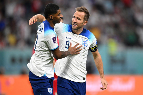 Harry Kane, right, hugs Marcus Rashford.