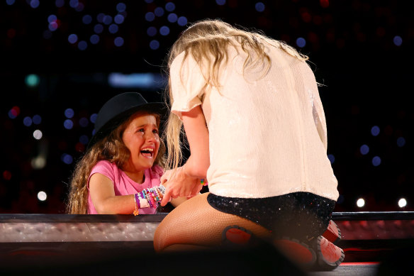 Milana receiving the hat from Swift at the MCG on Friday night. 