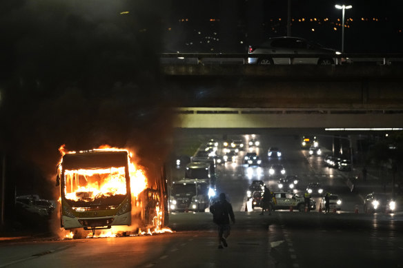 Supporters of Brazilian President Jair Bolsonaro clash with police setting fire to several vehicles and allegedly trying to storm the headquarters of the Federal Police in Brasilia on December 12.