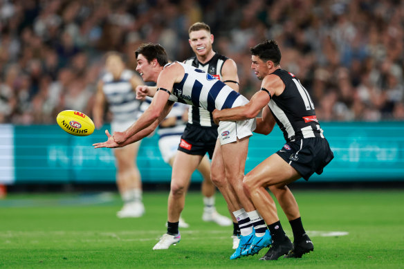 Geelong recruit Oliver Henry is tackled by Collingwood star Scott Pendlebury.