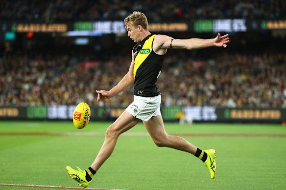 Tom Lynch of the Tigers kicks for goal.