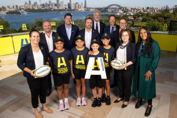 (L to R) Shannon Parry of the Wallaroos, Wallaroos head coach Jay Tregonning, Rugby Australia chair Hamish McLennan, Rugby Australia CEO Andy Marinos, RA president David Codey, Phil Kearns of the bid team, World Rugby CEO Alan Gilpin, Josephine Sukkar and Mahalia Murphy of the Wallaroos pose with junior rugby players during an Australian Rugby World Cup bid event at Taronga Zoo.