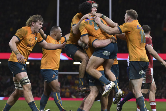 Australia players celebrate victory against Wales.