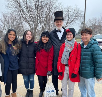 In Iowa, Andrew Sun, wearing a green jacket, and his friends from Duke University with a Trump fan dressed as President Abraham Lincoln.