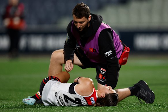 Georgia Patrikios in the hands of St Kilda medical staff.