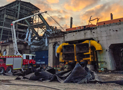 The aerial pumper in action in Gippsland. It has an extendable arm that can reach up walls of coal, reducing the risks to firefighters.