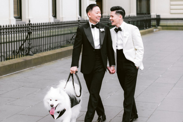 Tony Tran, right, and husband Jake Nguyen on their wedding day, November 11, 2023, with dog Louis.