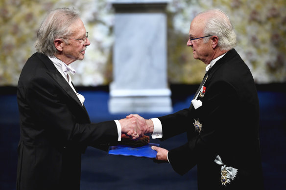 Austrian author Peter Handke, left, receives the 2019 Nobel Prize from King Carl Gustaf of Sweden, during the Nobel Prize award ceremony at the Stockholm Concert Hall.