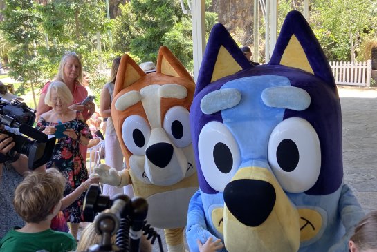 Bluey and sister Bingo pose with children at Brisbane’s Howard Smith Wharves, where Bluey’s World was announced on Sunday.