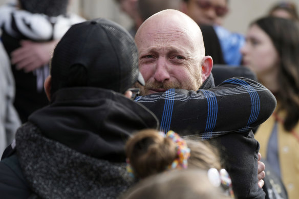 Nic Grzecka, right, co-owner of Club Q, is consoled by a supporter at a ceremony to acknowledge the massacre.