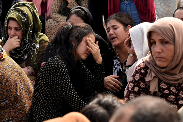 Relatives grieve for teenage soldier Adnan Hassan. It took his family four days to retrieve his body from the rubble. 