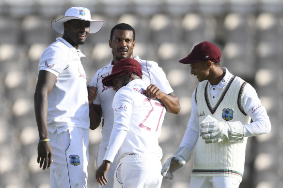 Shannon Gabriel (second left) celebrates Ollie Pope's dismissal with teammates.