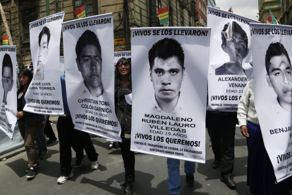 Students from the Universidad Mayor de San Andres of Bolivia hold banners with photos of the 43 disappeared students from the Rural Normal School of Ayotzinapa in the state of Guerrero, Mexico, during a support rally in Bolivia in 2014. 