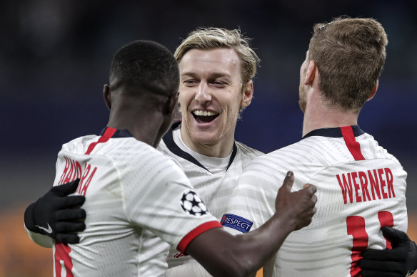 Leipzig's Emil Forsberg celebrates his team's fourth goal with teammates.