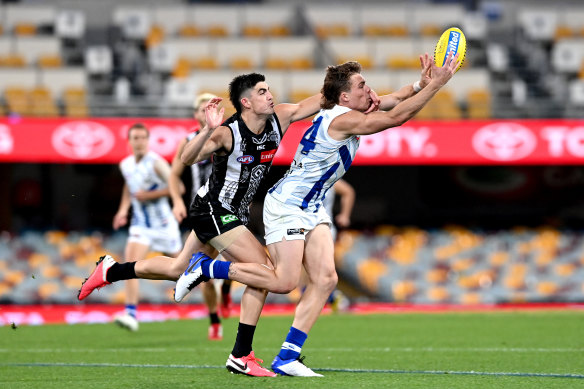 Collingwood and North Melbourne do battle under lights at the Gabba.