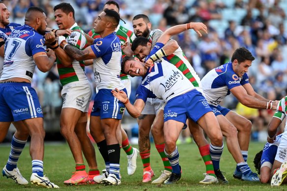 Bulldogs and Rabbitohs players clash during their Good Friday match.