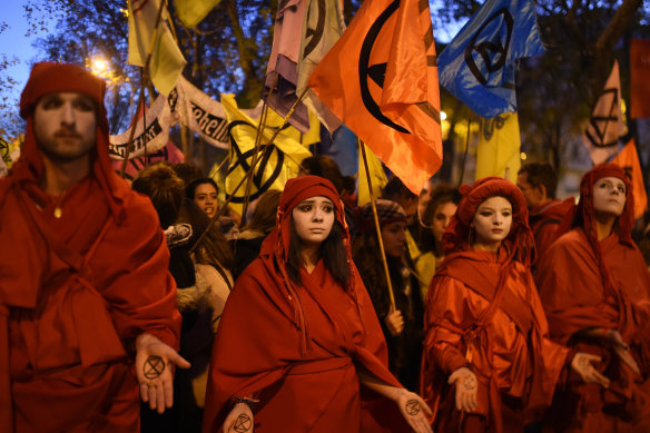 Climate activists march in silence during a 'Fridays For Future' protest in Madrid during the COP25 climate talks.