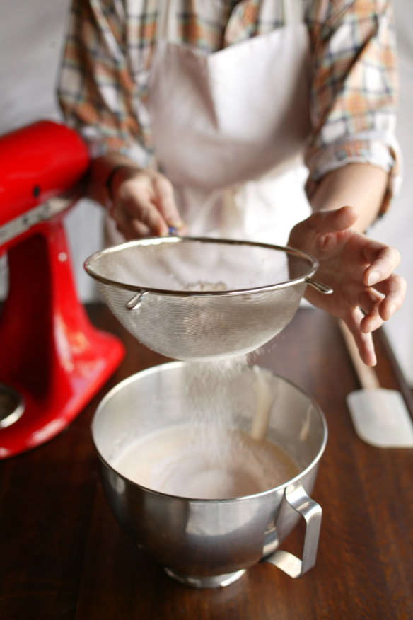 Gently tap the fine mesh sieve to work the flour through.