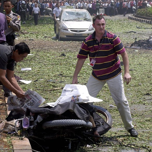Dooley covers the body of a bike rider who died in the blast.