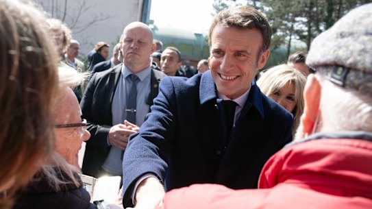 French President Emmanuel Macron greets members of the public after voting in Le Touquet.