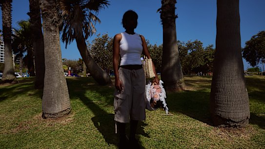 Meg* holding the items she has stolen over the years.