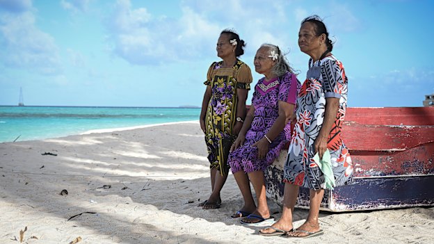 Castle Bravo survivors (from left) Susan Ned, Kathy Joel and Mina Titus on a beach on Mejatto Island in the Marshall Islands. Greenpeace flagship, the Rainbow Warrior III, is in the background.