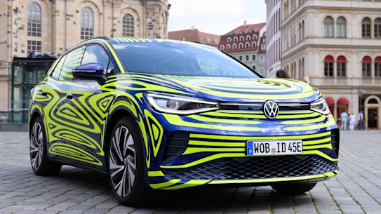 FILE - In this July 29, 2020 file photo, a VW ID.4 stands in front of the Frauenkirche on the occasion of a Volkswagen vehicle presentation on the Neumarkt in Dresden, Germany. The VW ID.4 is Volkswagen’s first purely electrically driven SUV and is built in Zwickau. (Sebastian Kahnert/dpa via AP)