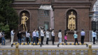 People line up for COVID-19 tests at a makeshift testing site in Beijing’s Chaoyang District.