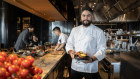 Woodcut Executive Chef Daniel Leyva serving Southern Rock Lobster,  in front of one of the open kitchens at Crown Sydney