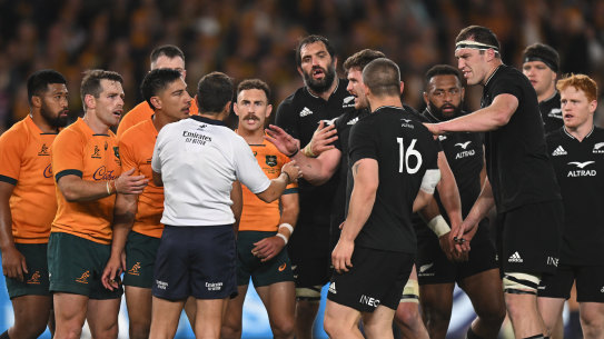 Chaos ... Raynal at the centre of the action after his 79th minute call.