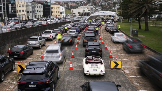 Cars queue for testing at SydPath’s Bondi Beach testing clinic on Monday.