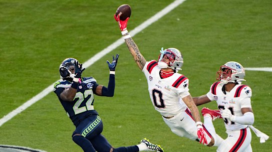 New England Patriots cornerback Christian Gonzalez (0) breaks up a pass intended for Seattle Seahawks wide receiver Rashid Shaheed.